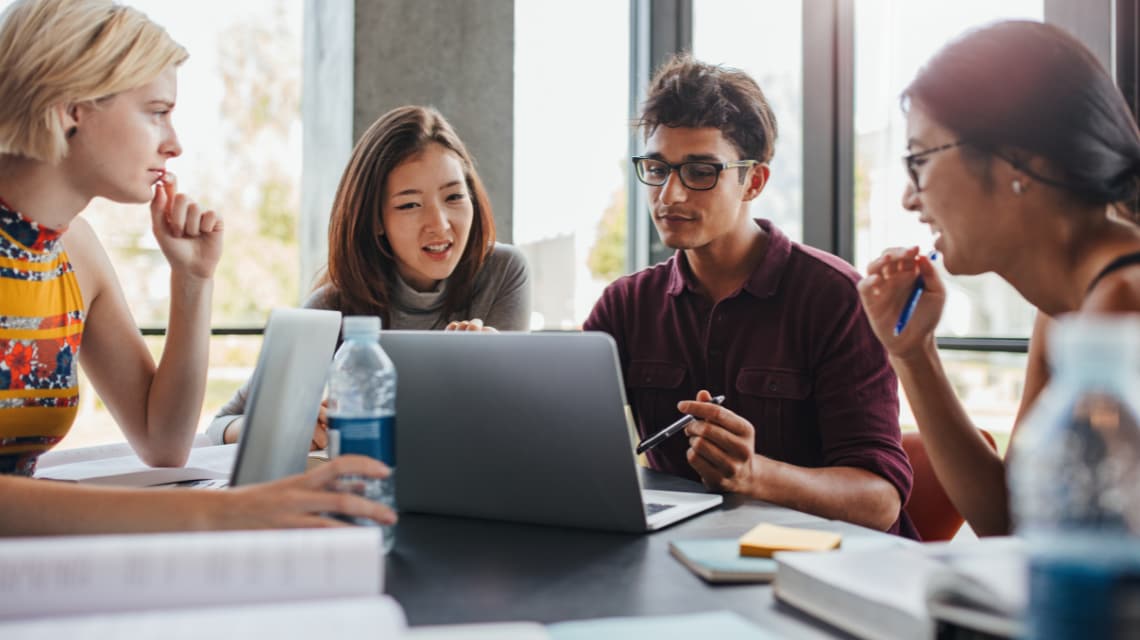 Young person with a back on a bridge with skyscrapers in the distance
